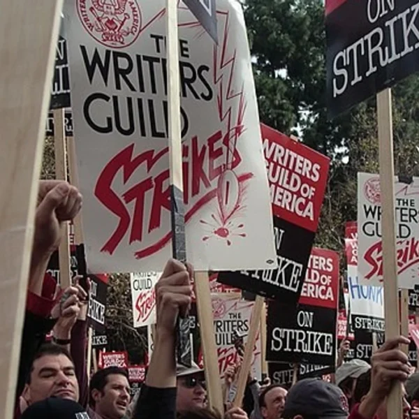 a crowd of people holding strike signs 1