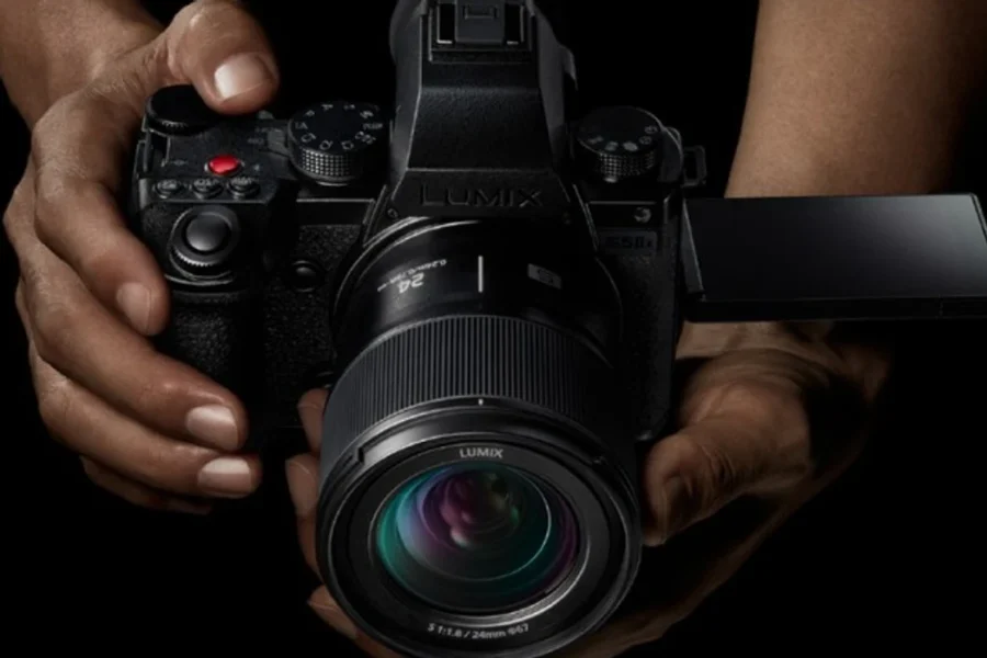 the panasonic s5 ii being held by two hands 1