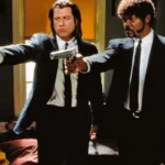 vincent vega played by john travolta and jules winnfield played by samuel l jackson pointing guns in pulp fiction 1